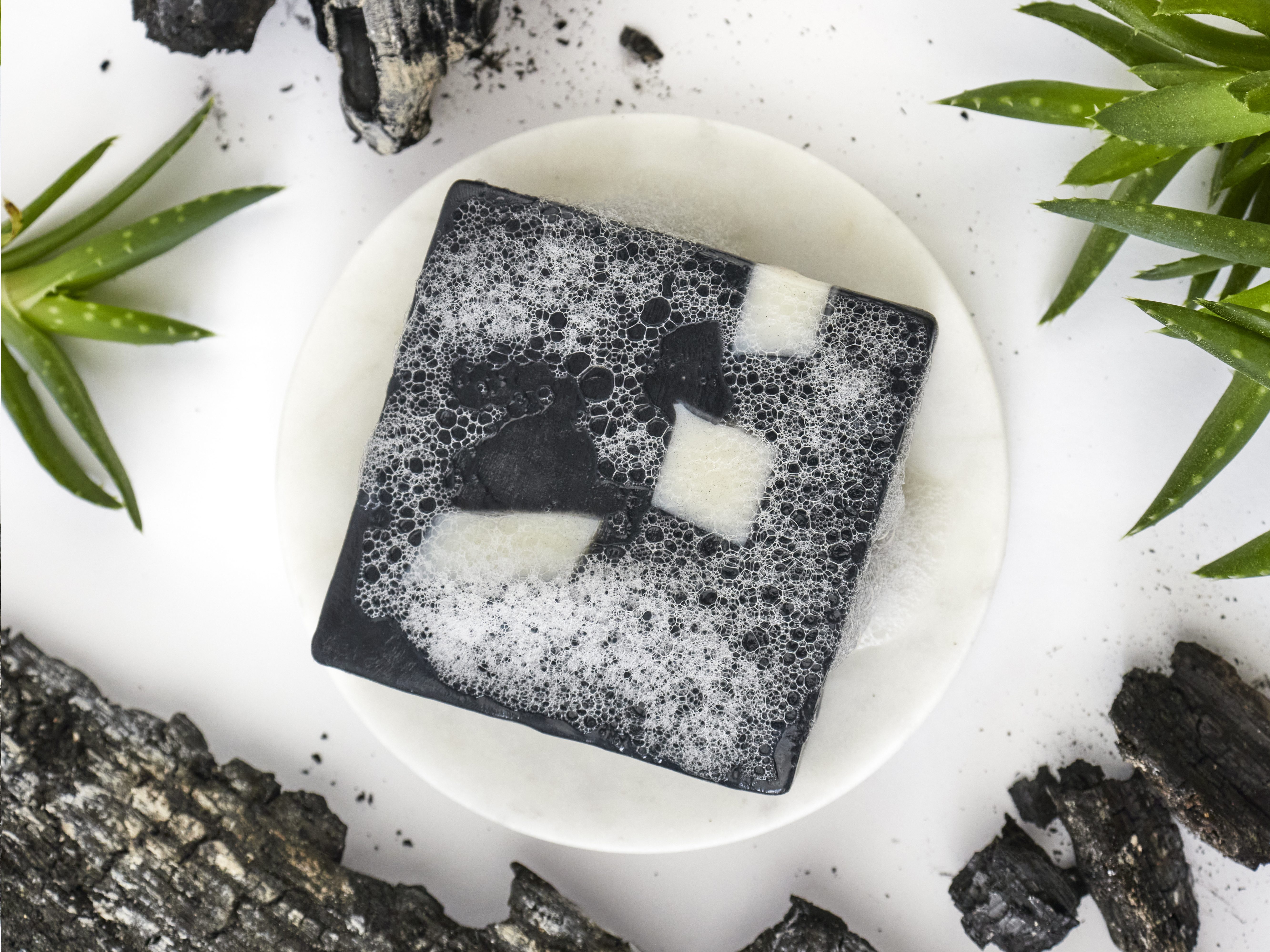 Product photography flat lay of charcoal aloe soap bar for Ash & Rose in Framingham, MA.